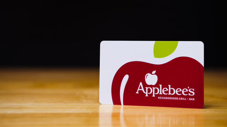 An Applebee's gift card is shown standing up on a table