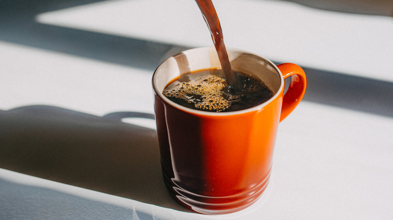 A cup of coffee being poured.