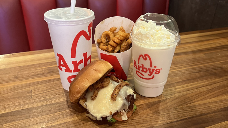 Arby's Deep Fried Turkey Gobbler with drink, shake, and fries on a wood table