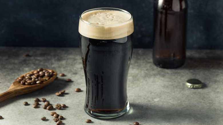 A pint of coffee stout beer sitting on a table.