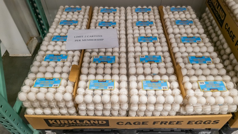 cartons of Kirkland brand eggs with sign that limits 2 per customer