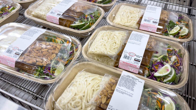 trays of costco udon noodle prepared meals inside a store