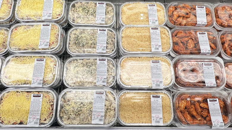 trays of costco prepared meals inside a store