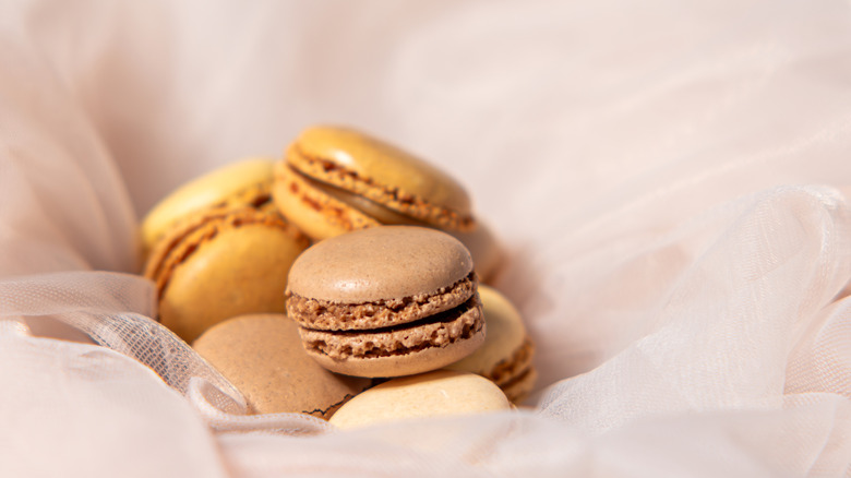 A small pile of macarons in a tulle cloth