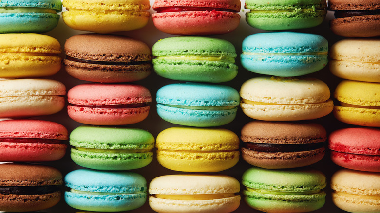 Rows of colorful macarons laid out on a flat surface