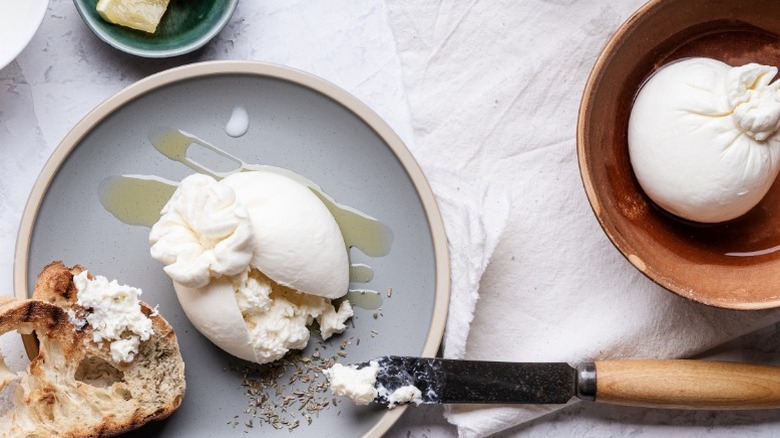 Burrata cheese, cut open and spread on a piece of bread