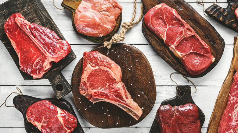 Many steaks placed on a table.