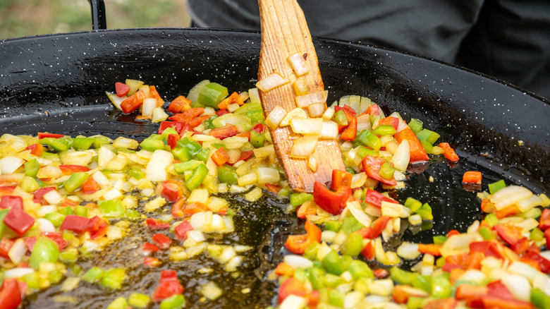 Sofrito base of onions, peppers, and garlic sauteeing in a pan