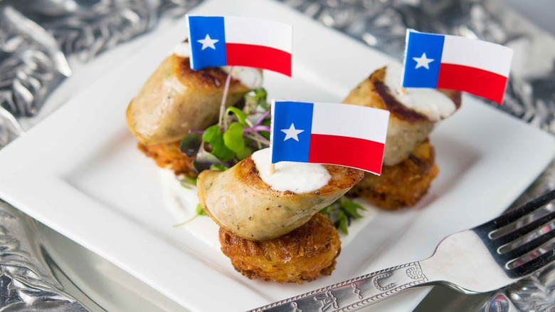 Rabbit rattlesnake sausage on plate with mini flags