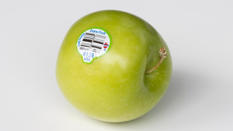 Green apple with sticker