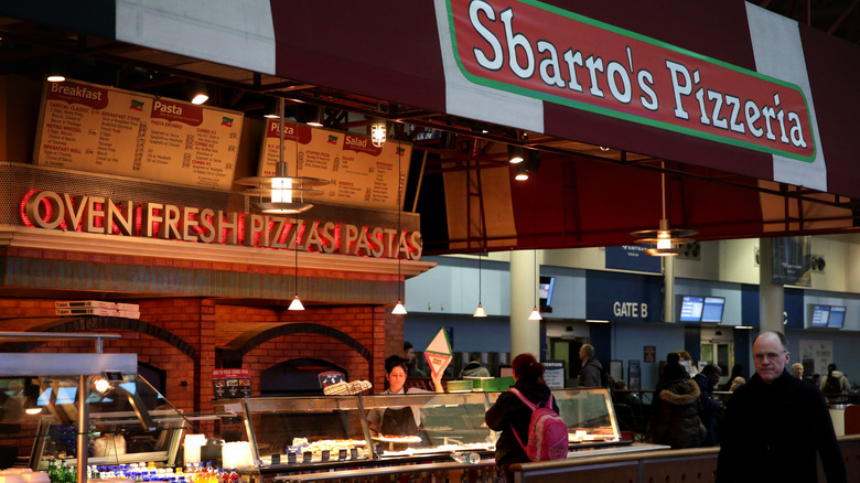 Customers wait in line at a Sbarro location