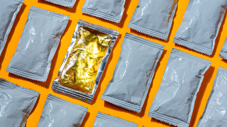 Single serving sauce packets with one showing honey inside the plastic