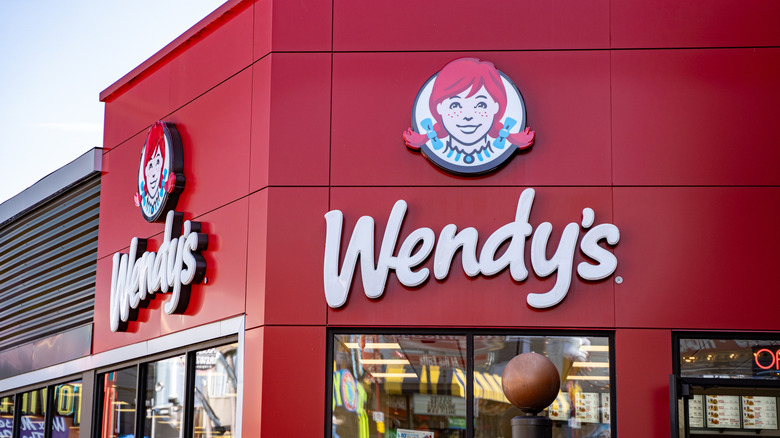 The exterior of a red Wendy's location during the daytime