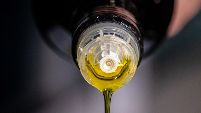 Olive oil poured from a bottle