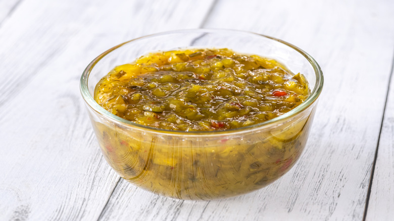 Small glass bowl of pickle relish on white tabletop