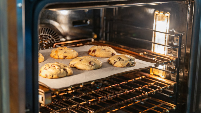 thick chocolate chip cookies baking in the oven