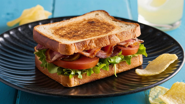 BLT sandwich on a plate with chips