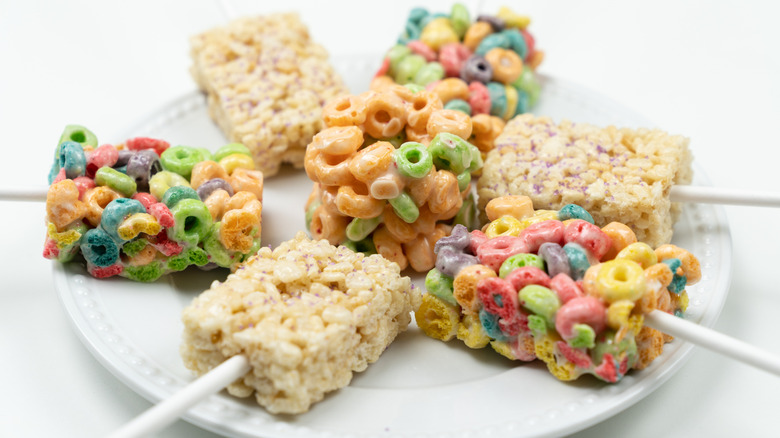 Marshmallow and cereal treats on sticks on a plate