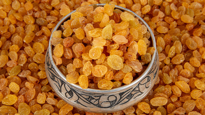 Metal bowl of golden raisins