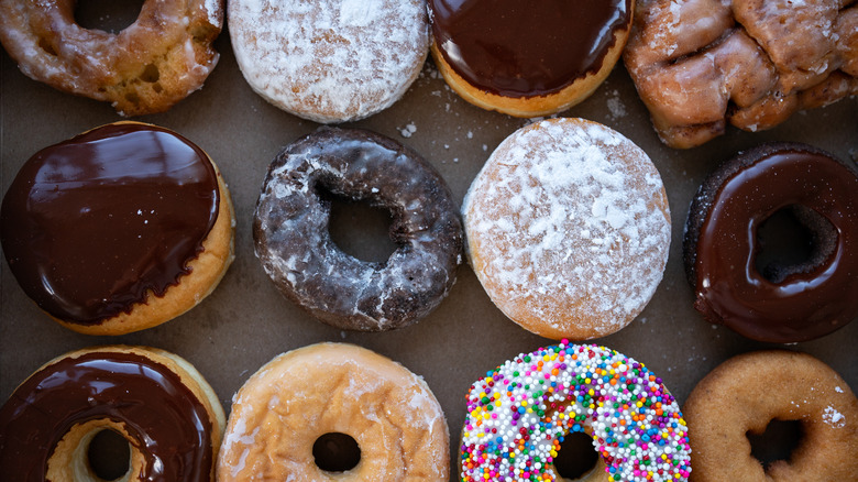 A box of donuts in various flavors and colors