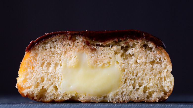 A Boston cream donut cut in half