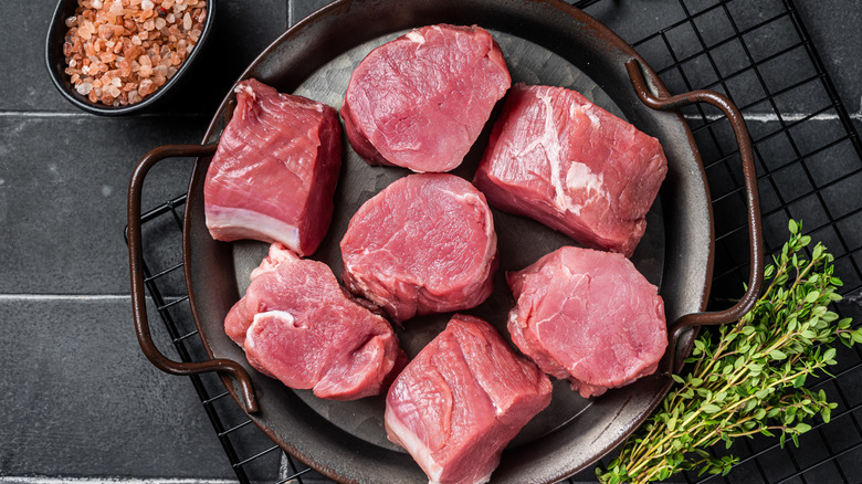 Raw pork tenderloin in a skillet