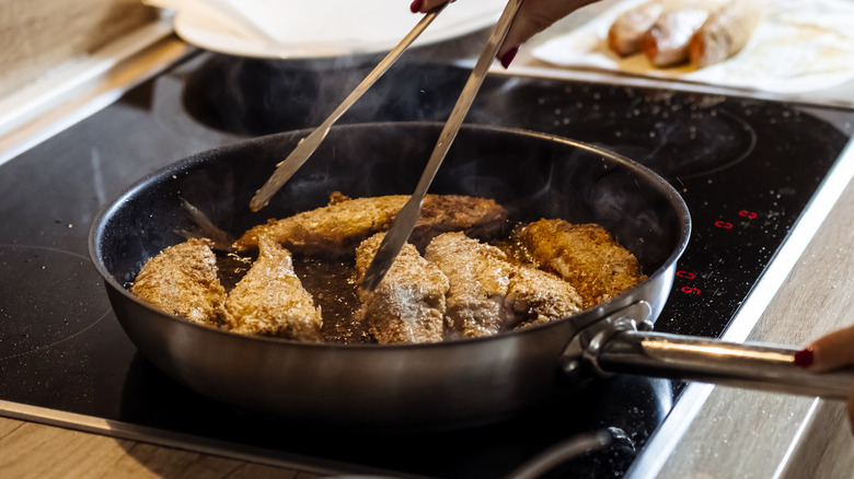 fish frying in a pan