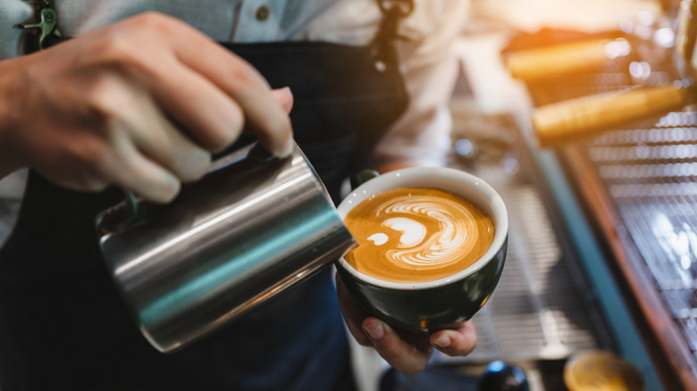 Barista pouring coffee