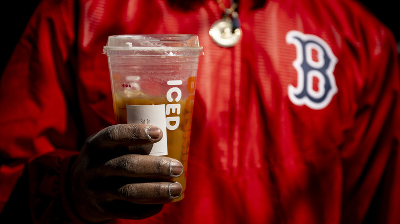 Hand holding iced Dunkin' coffee