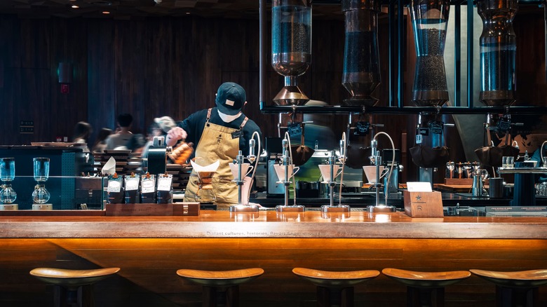 Starbucks barista pouring drip coffee