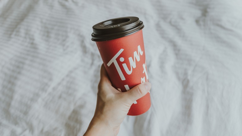 Hand holding Tim Hortons cup