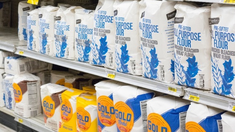 Bags of flour stocked on shelves at the grocery store