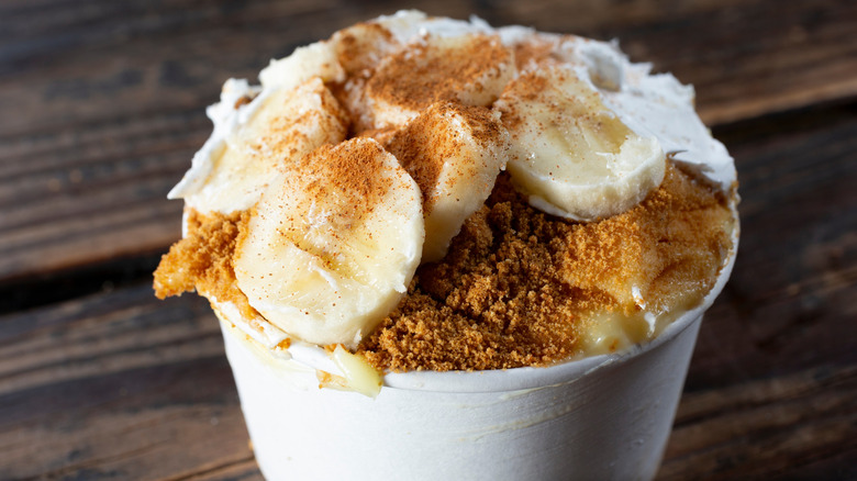 A close up photo of banana pudding in a cup