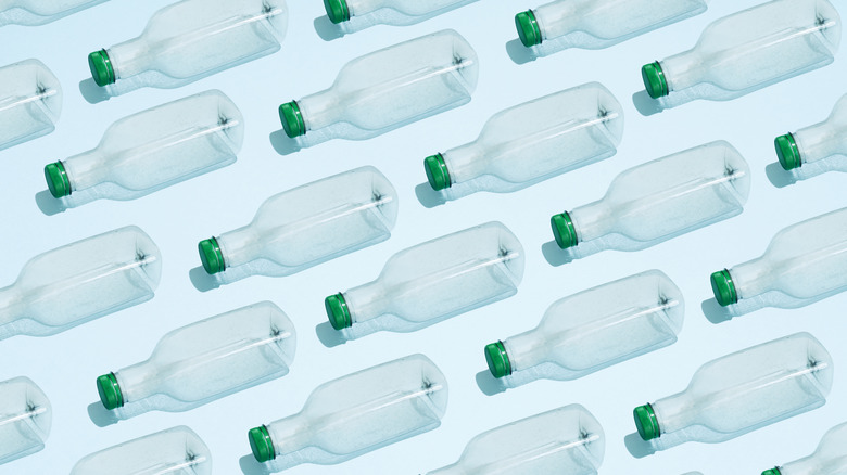 Empty water bottles lying on their side in rows