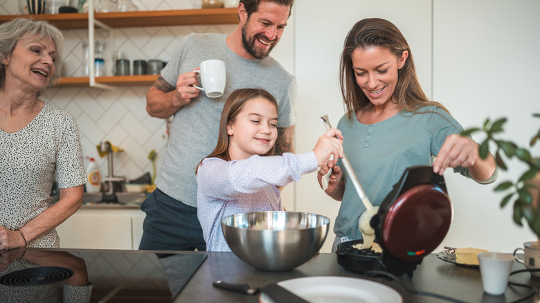 Family making waffles together