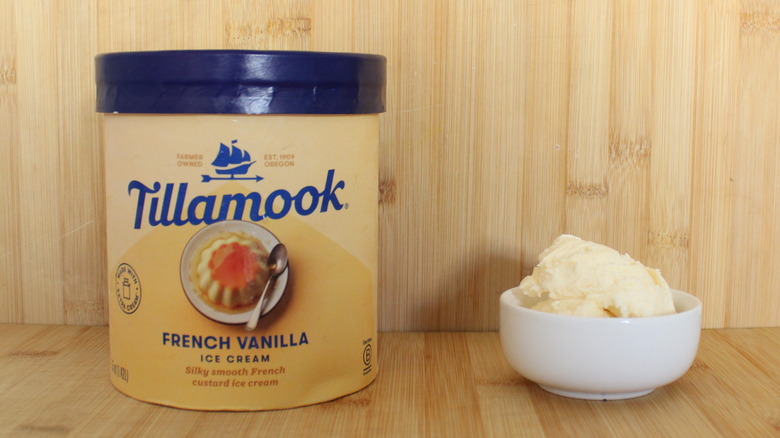 Container and bowl of Tillamook vanilla ice cream