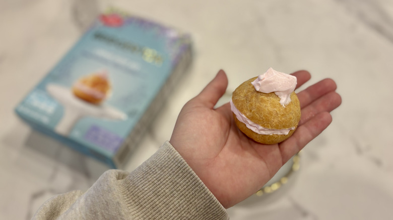 holding a finished creme puff