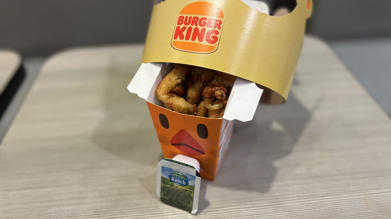 Burger King's Fried Pickle Ranch Whopper next to a box of Pickle Fries