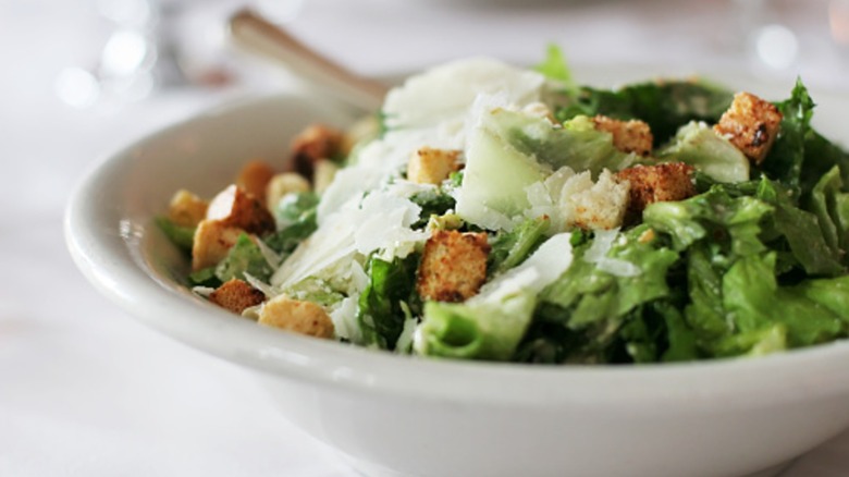 Caesar salad in a white bowl