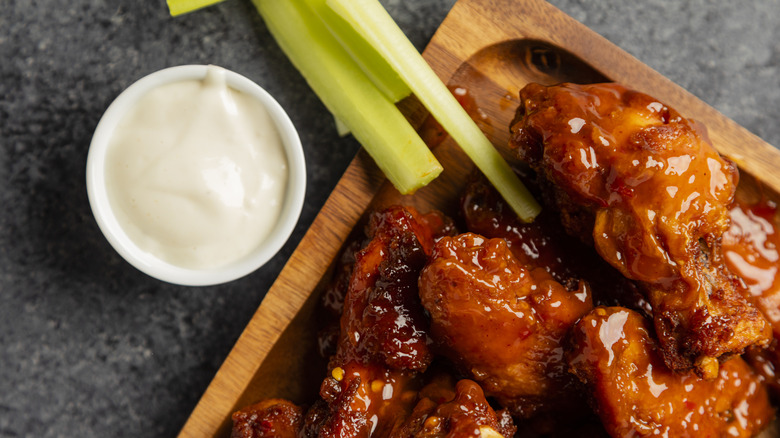 Ranch dressing with celery and barbecue wings