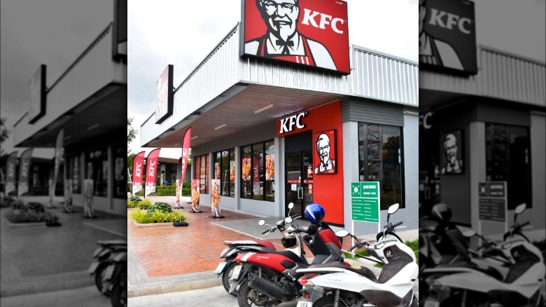 Motorized bikes are parked outside a KFC location