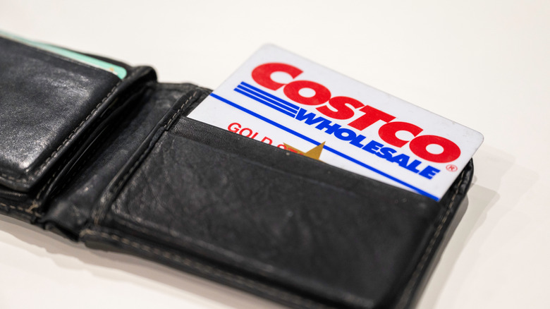 A Costco card peeking out of a leather wallet