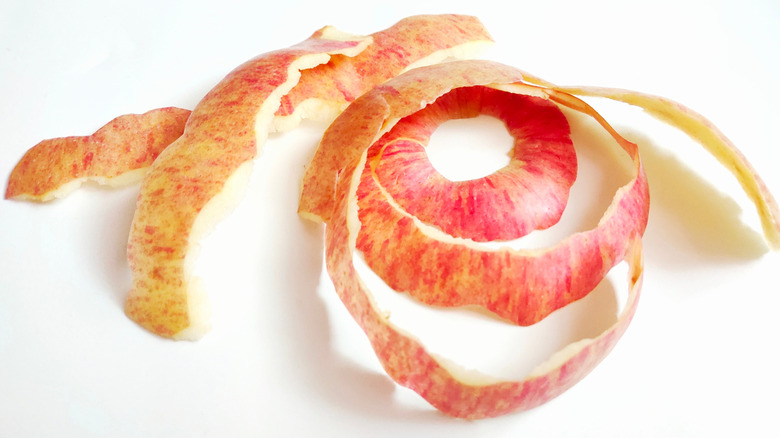 red apple peels on white background