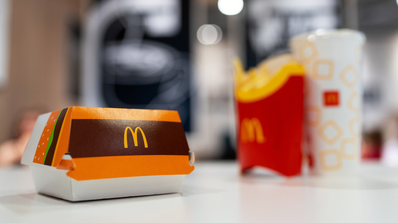 McDonald's burger box, fries, and drink on white table