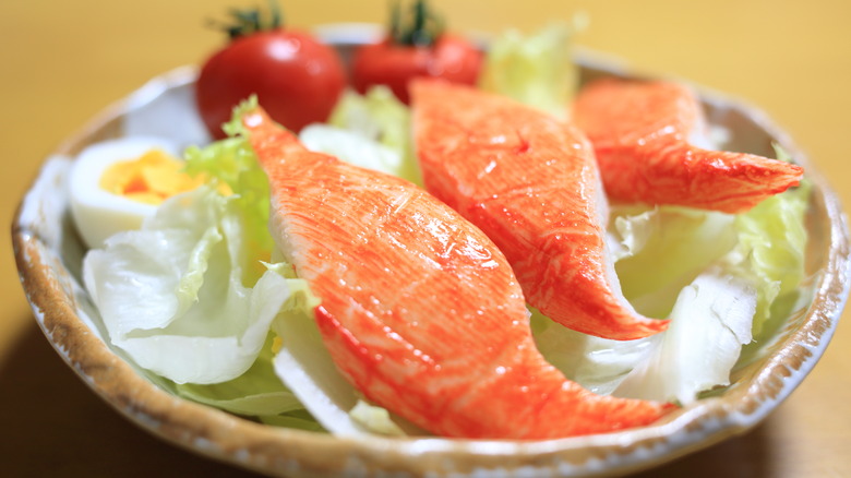 Imitation crab legs on a green salad