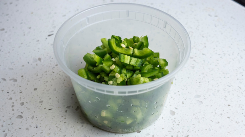 a deli container full of diced jalapeños