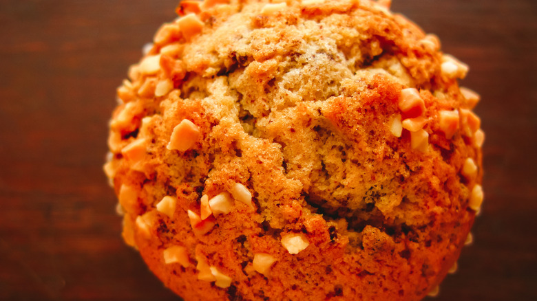 A close up of a muffin top with nuts