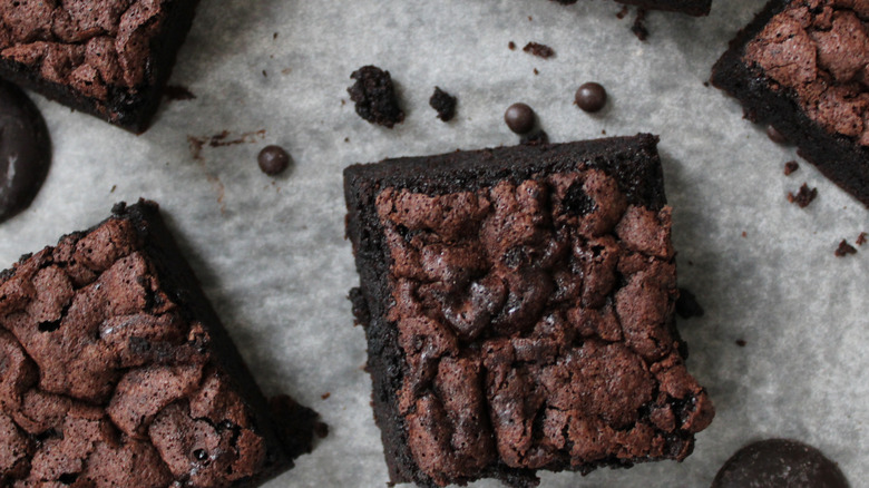 Chocolate brownie squares on a grey background