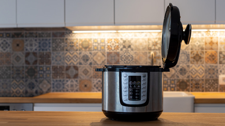 An opened instant pot in an empty kitchen