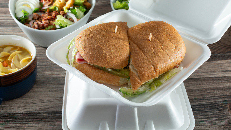 A sandwich inside a Styrofoam container.